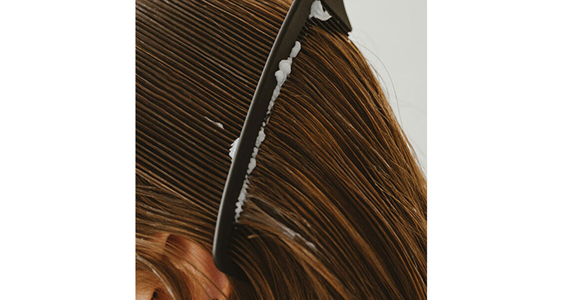 Why does menopause hair loss happen? | Model combing hair 